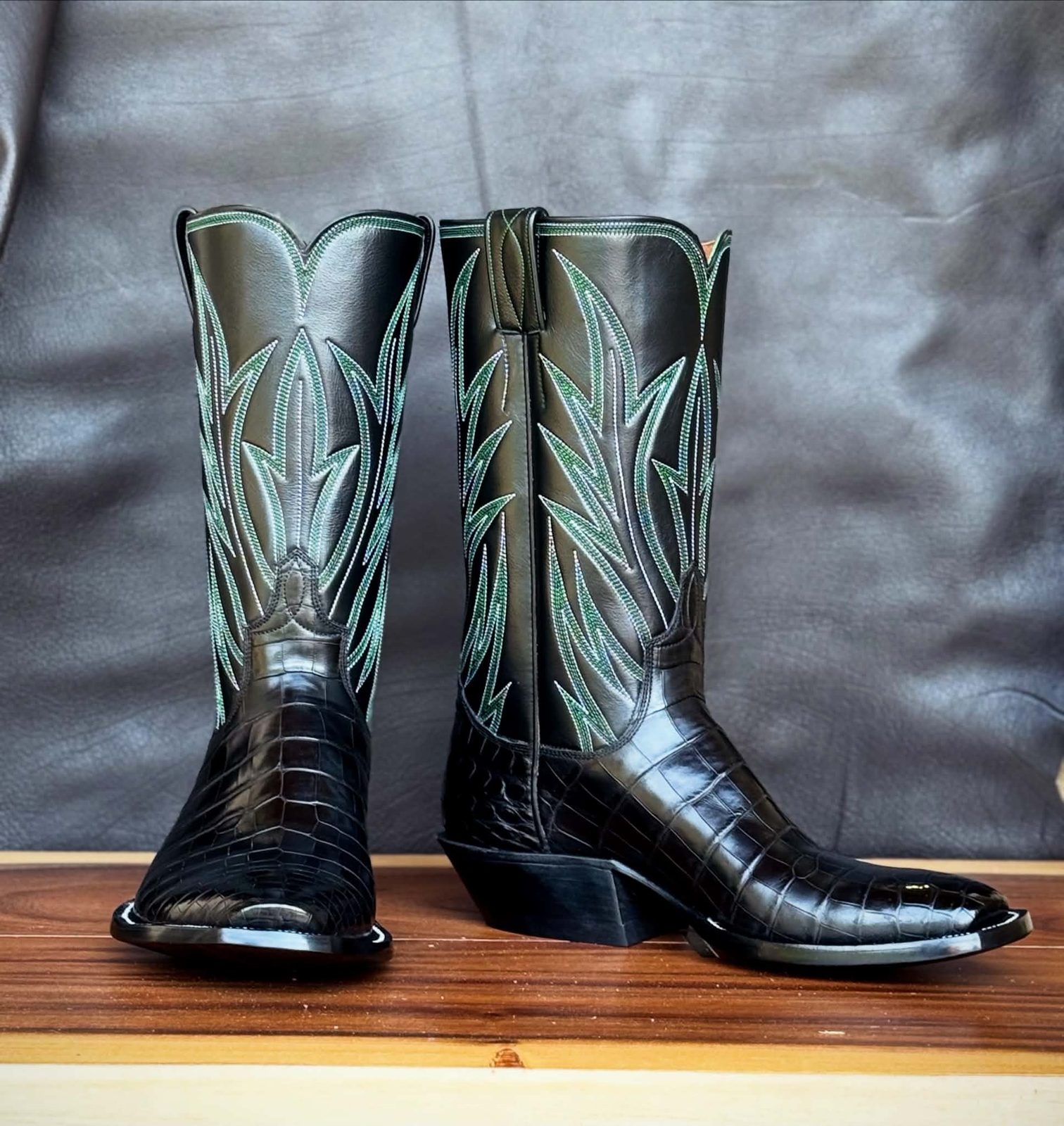 Black boot tops with teal ribcage stitching over black alligator vamps