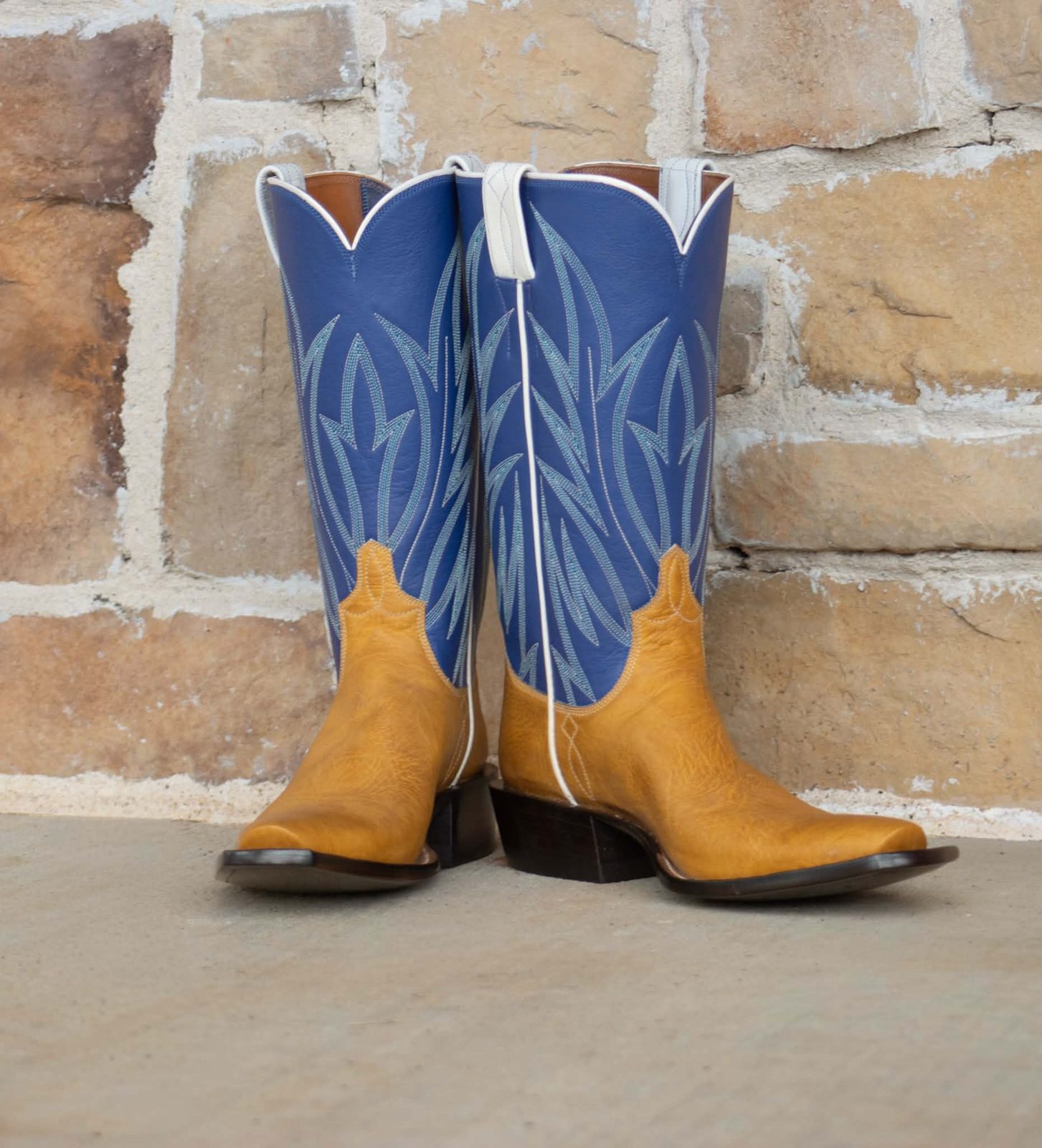 Cobalt blue boot tops with tonal stitching over tan roughout vamps and a square toe