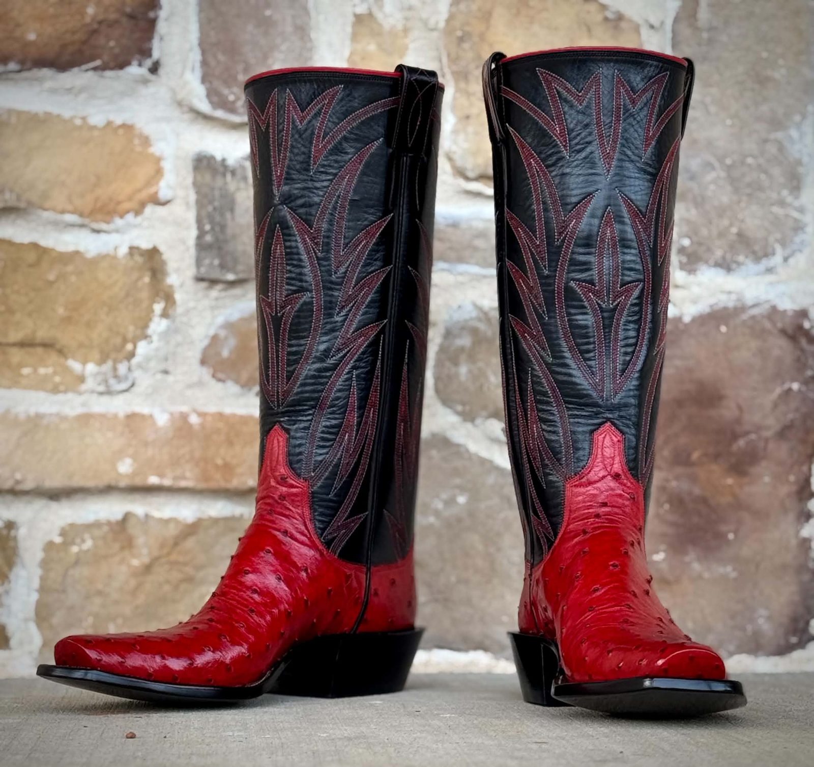 Black boot tops with red and white stitching over red full-quill ostrich vamps